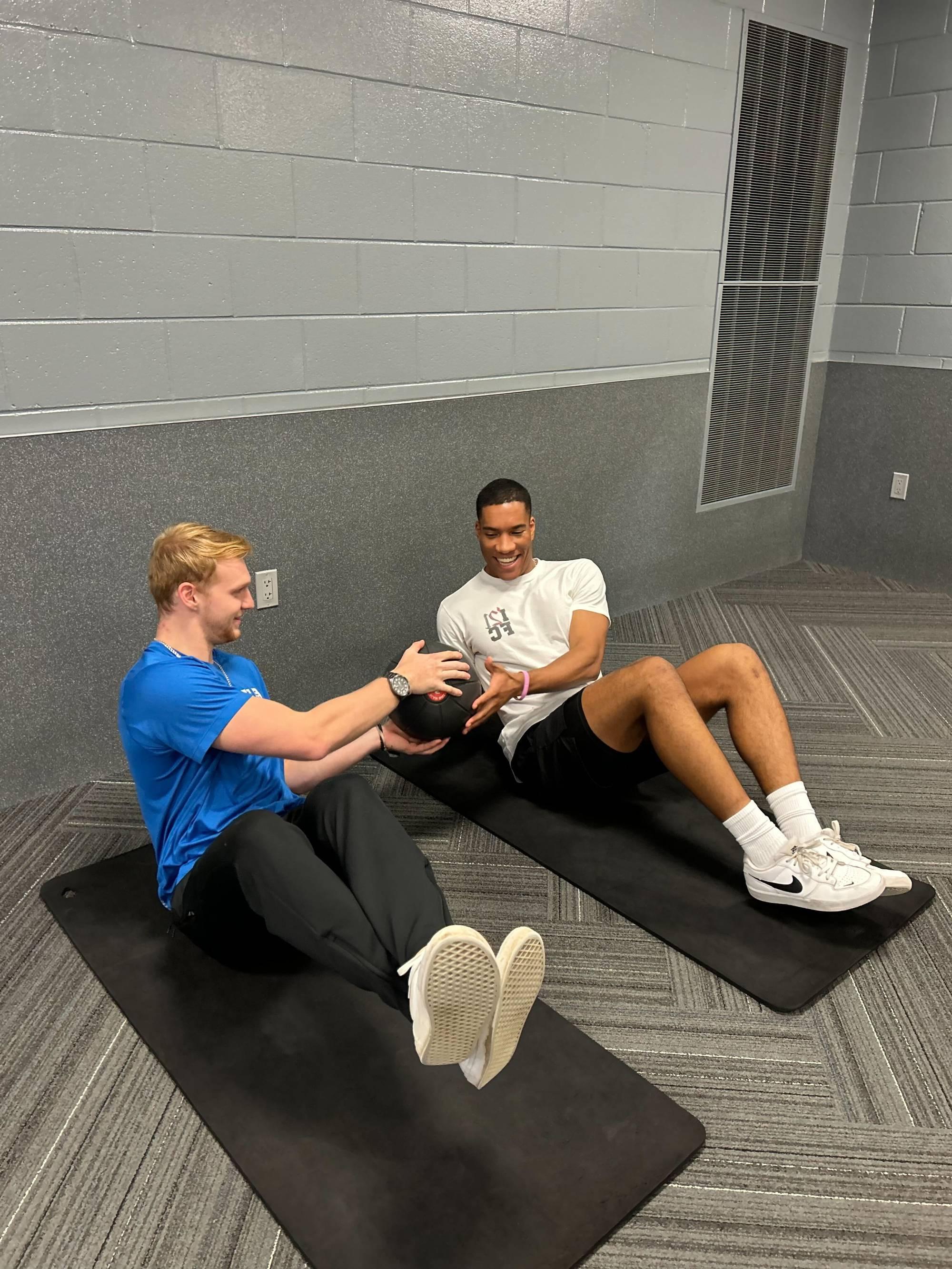 Trainer and client working on core